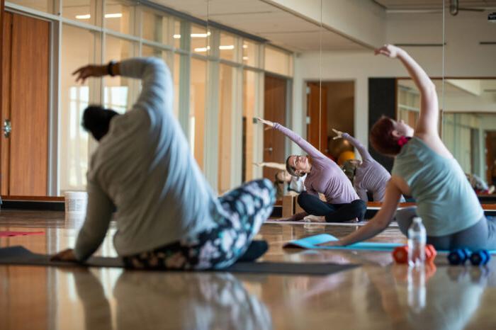 yoga students practicing yoga in studio.