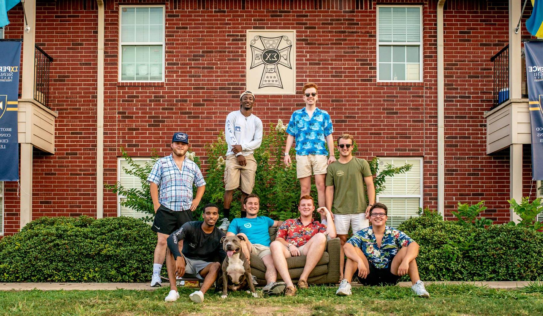 Group of members in front of Sigma Chi house.